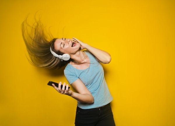 A girl dancing with headphones blasting.