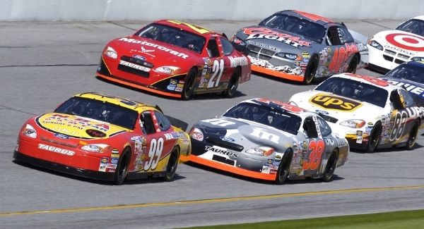 A group of racecars on a track.