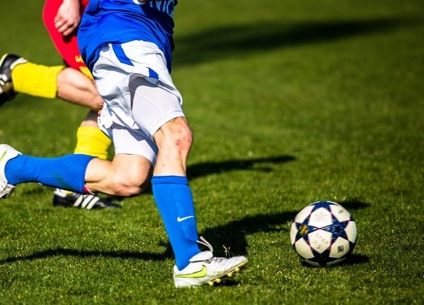 Two people playing soccer.